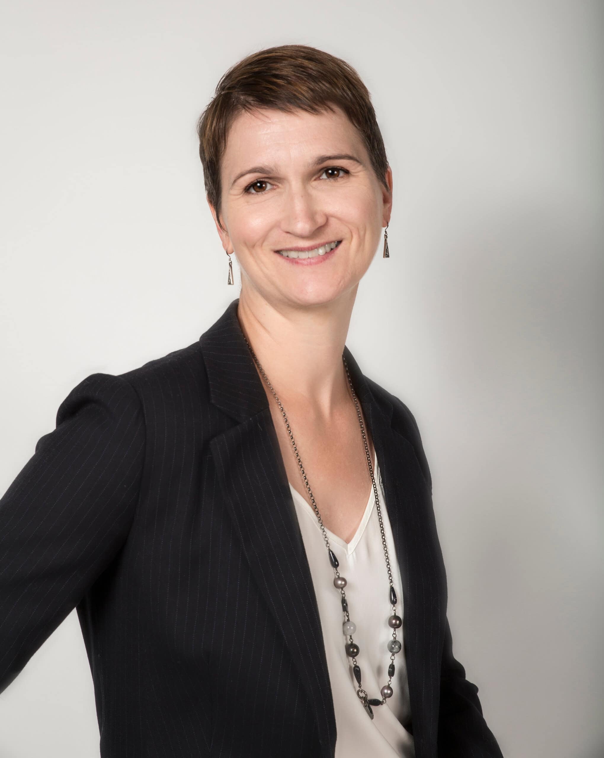 Karen Chovan stands against a grey background