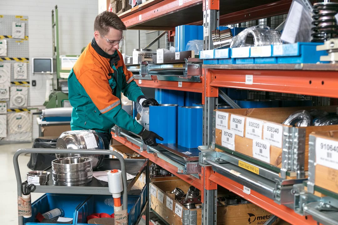 METS and miners partner for circularity 2 A storeman sorts through spare parts on a shelf