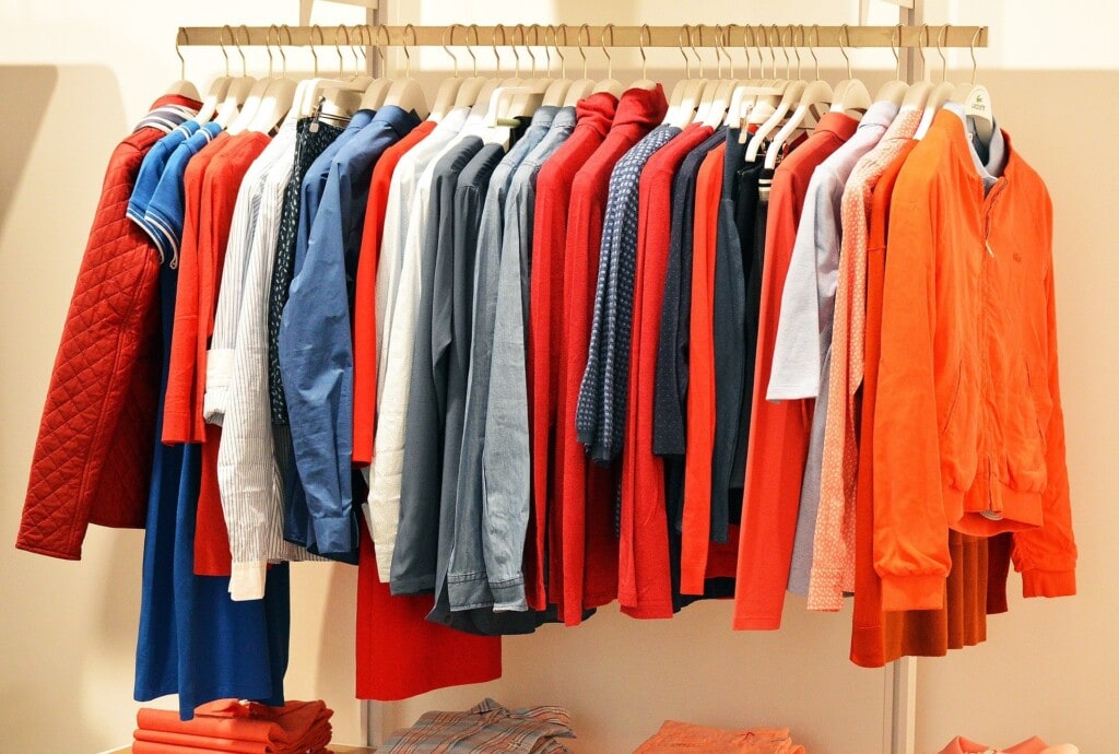 Consumerism & the mining industry: part 1 4 Colourful clothes hanging on a rail in a store