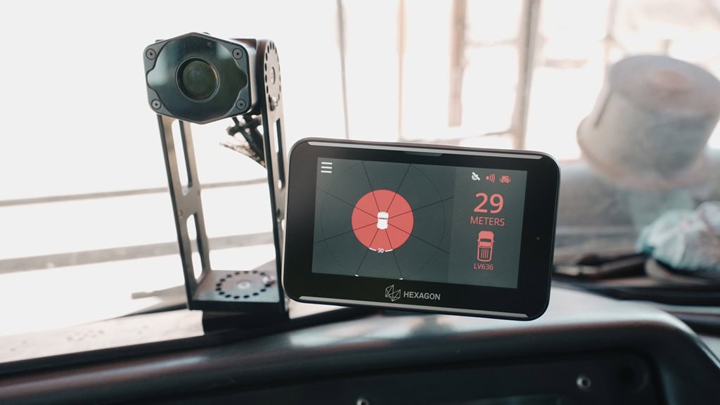 How collision avoidance technology became a strategic mining tool 3 Advanced mining technology sensor device displaying data on a digital screen mounted on a vehicle dashboard.
